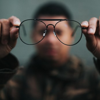 man holding glasses perspective